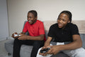 Teenage friends playing video game at home