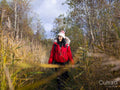 Female hiker walking through tall grass