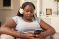 Girl in headphones using smart phone
