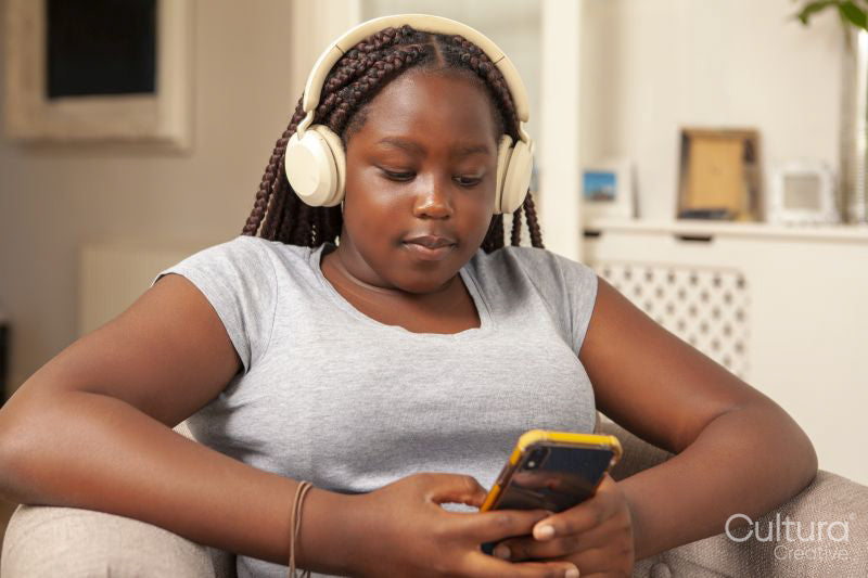 Girl in headphones using smart phone