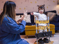 Mother playing with daughter in standing frame