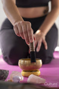 Close-up of woman with singing bowl in yoga studio