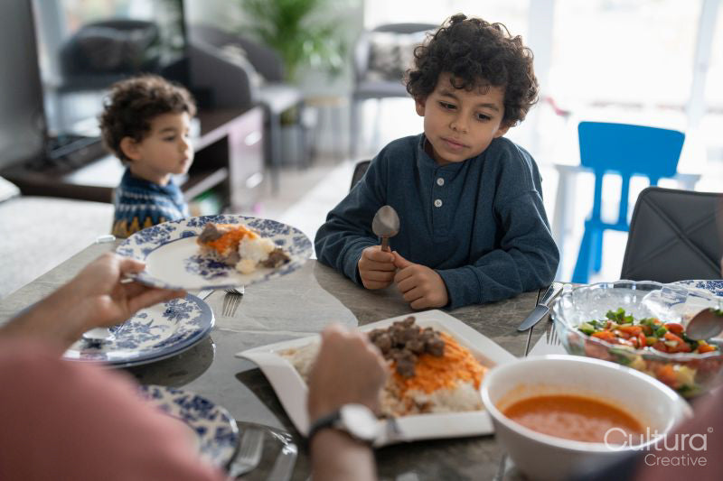 Mother and sons eating meal at home