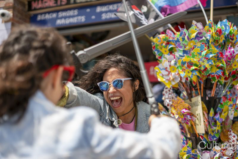 Smiling mother and daughter playing with toy swords
