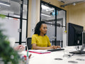 Office workers using computers in co-working office space