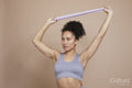 Studio portrait of athletic woman exercising with resistance band