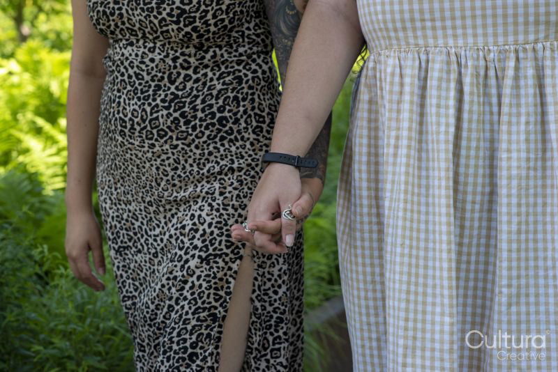 Midsection of couple holding hands