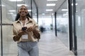 Happy businesswoman in office corridor