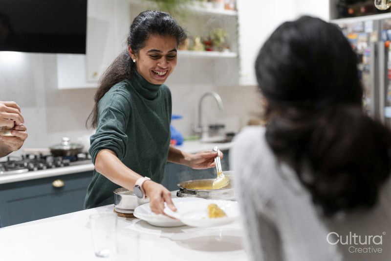 Woman serving food to daughter