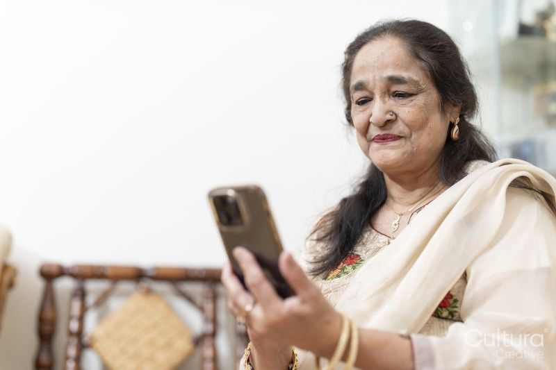 Portrait of senior woman using smart phone in living room