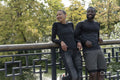 Smiling athletic man and woman relaxing in park