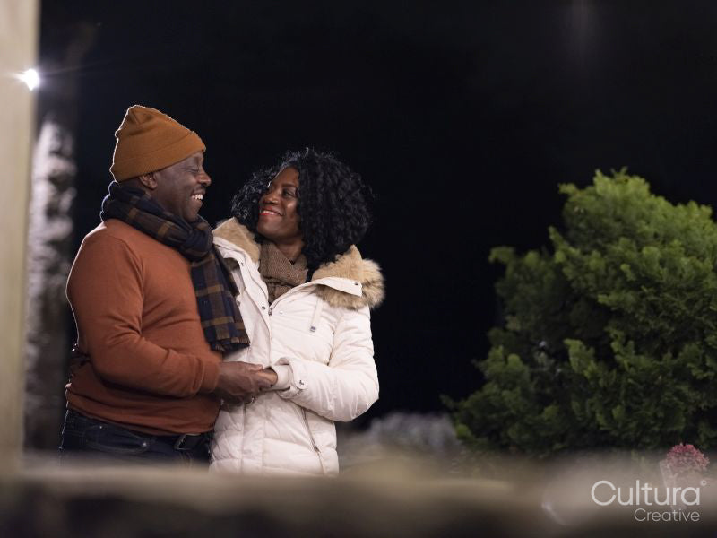 Mature couple holding hands outdoors at night