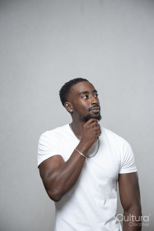 Man wearing white t-shirt and necklace