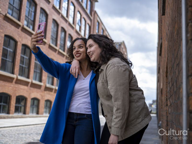Smiling couple taking selfie on street