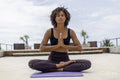 Woman meditating on terrace