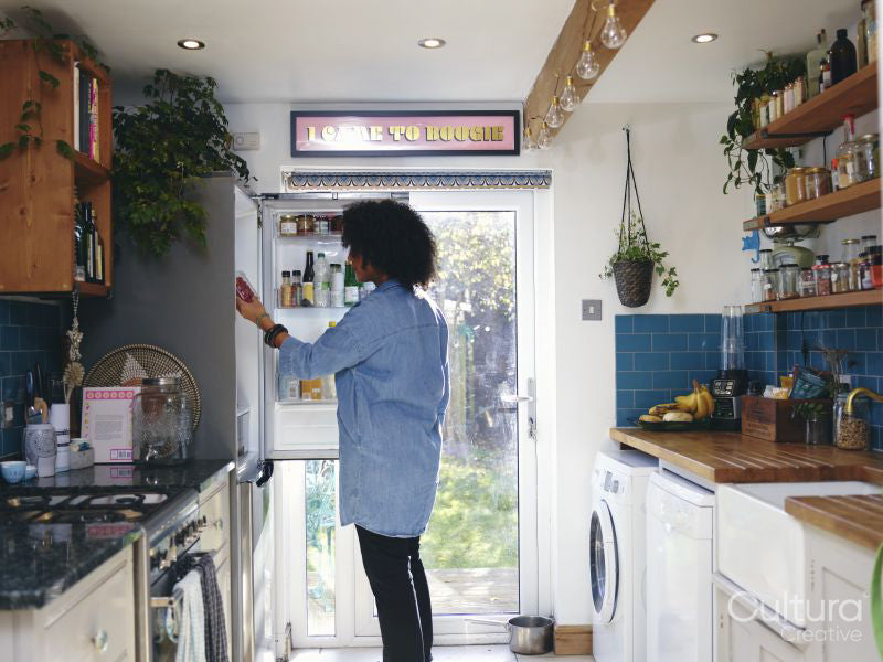 Woman opening fridge