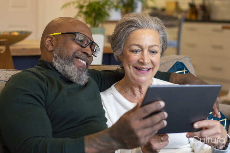 Senior couple using digital tablet at home