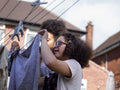 Two girls hanging laundry in backyard