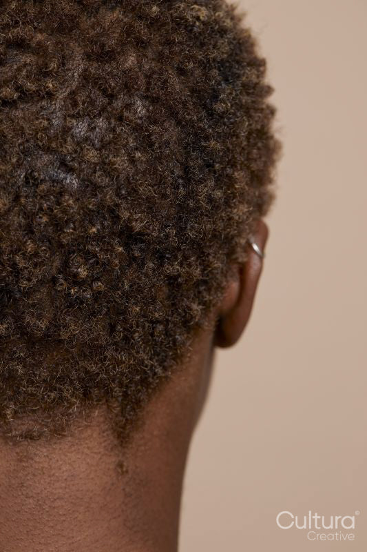 Close-up of woman's short curly hair