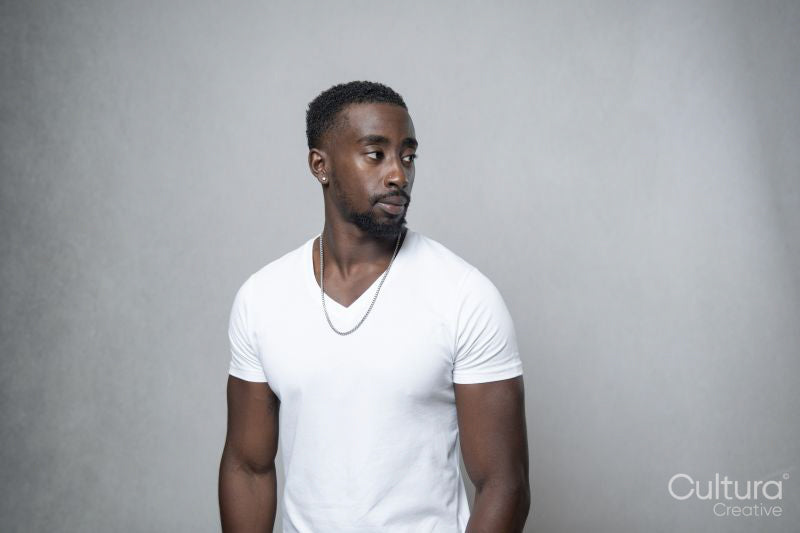 Portrait of man wearing white t-shirt and necklace