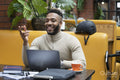 Man sitting in office lounge using laptop