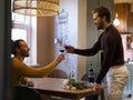 couple making wine toast at home