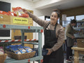 Portrait of female volunteer working in community food center