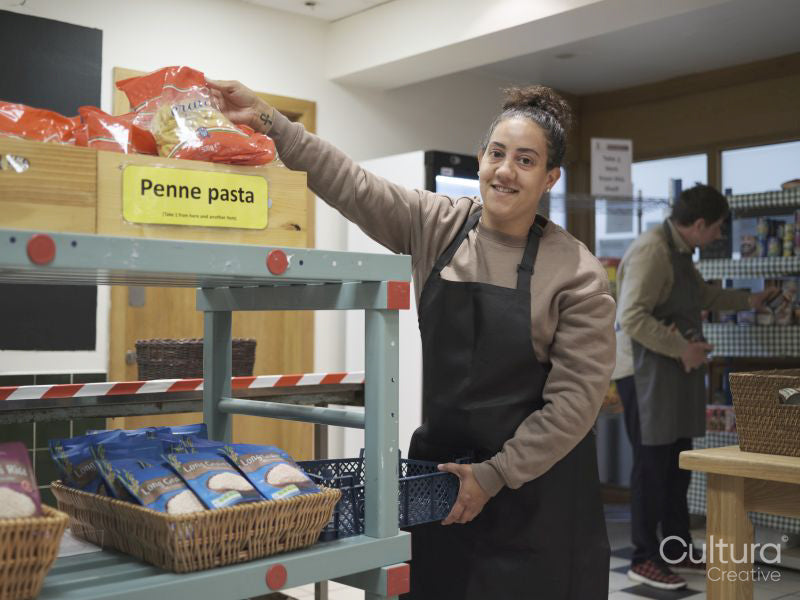 Portrait of female volunteer working in community food center