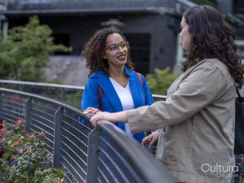 Smiling couple talking on bridge