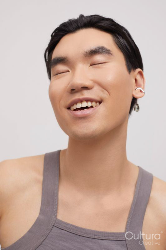 Studio portrait of handsome man with ear piercing