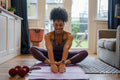 Young woman stretching at home