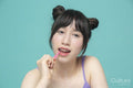 Studio portrait of girl brushing braces with interdental brush