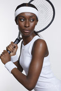 Studio portrait of athletic woman with tennis racket