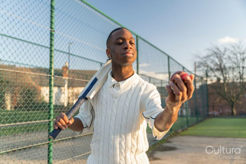 Portrait of cricketer standing on outdoors sports court
