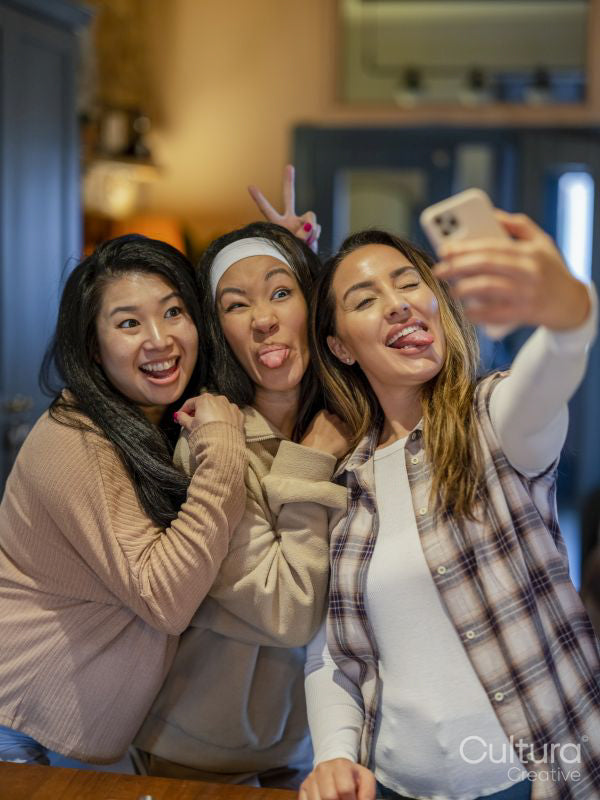 Portrait of friends taking selfie at home