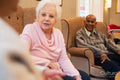 Senior people sitting in armchairs and talking together