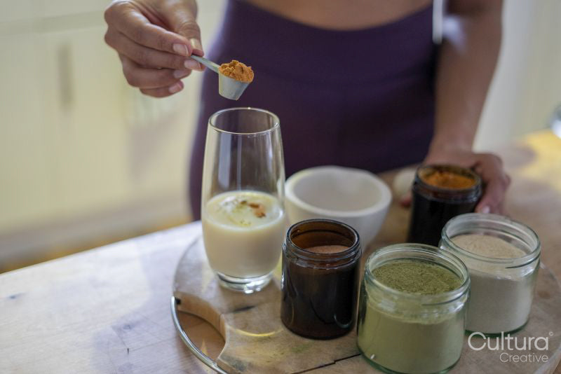 Woman preparing healthy drink at home