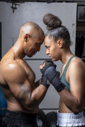 Woman and man face to face in boxing ring