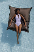 Overhead view of woman relaxing in swimming pool