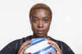Studio portrait of female soccer player with ball
