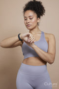 Studio portrait of athletic woman checking smart watch