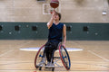 Male basketball player in wheelchair spinning ball