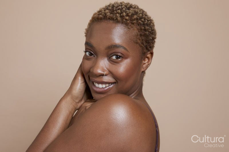 Studio portrait of smiling woman with nose ring