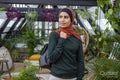 Portrait of smiling woman wearing headscarf at home