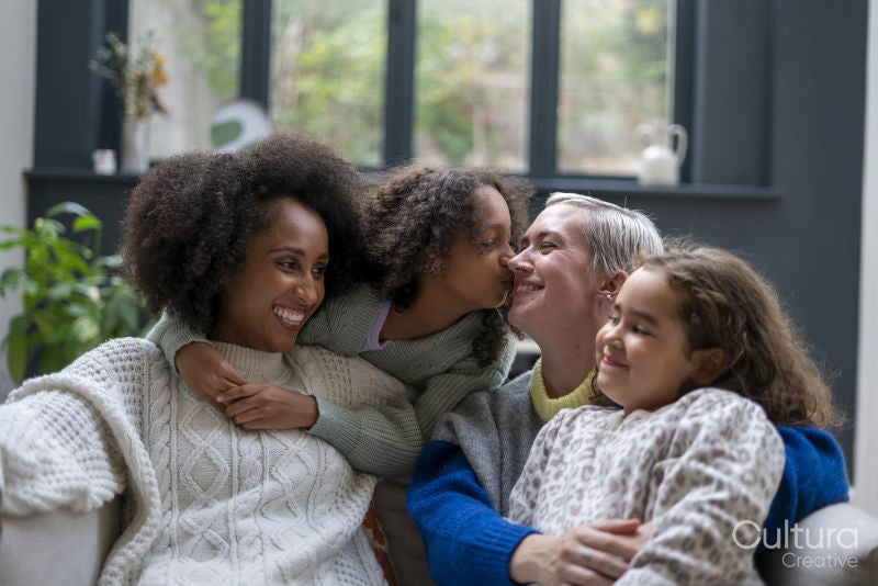 Smiling women with daughters at home