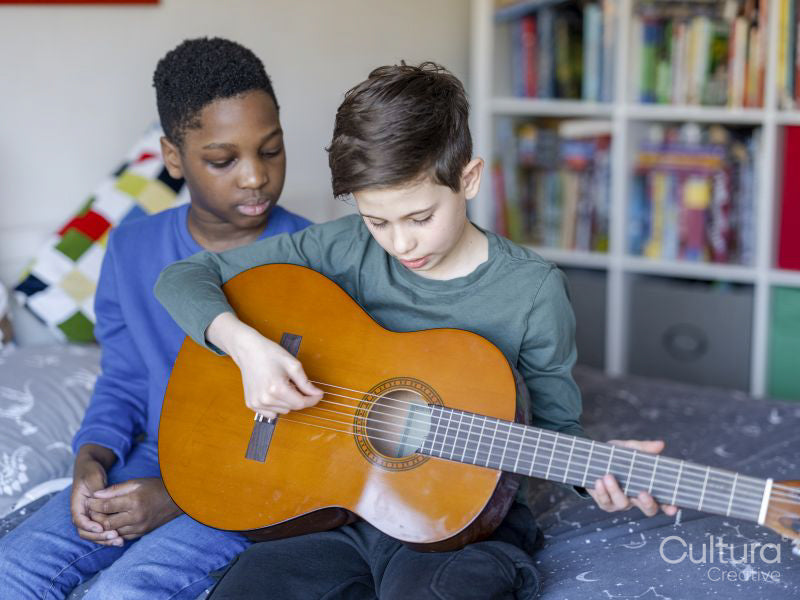 Boy friends playing guitar at home