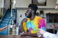 Man laughing to friend during card game at home