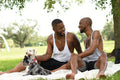 Louisiana, Smiling couple with dogs having picnic on lawn in park