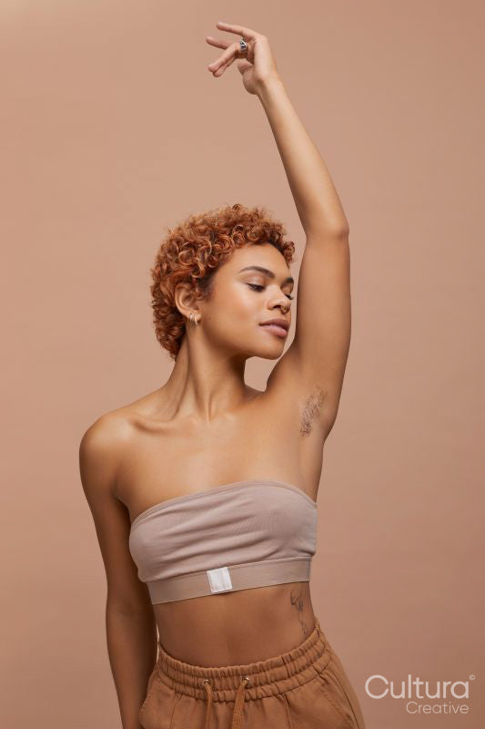 Studio portrait of non binary person wearing strapless bra