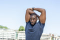 Mid adult man stretching in urban setting